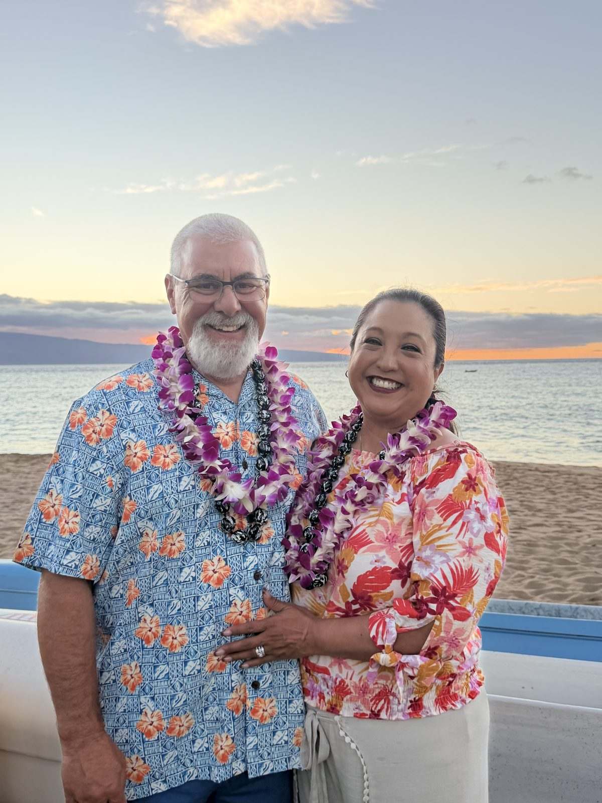 Marty and Roianne at sunset in Hawaiian leis